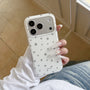 White matte star phone case with silver star print held in hand