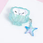 Open aqua shell-shaped AirPods case holding white AirPods, styled with pearl and starfish detailing and a dangling starfish charm.