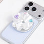 Close-up of a white 3D-printed jewel rosette phone grip stand with heart and faceted decorative accents on a silver base.
