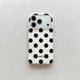 Ivory white polka dot phone case with bold black dots and raised camera surround on a light neutral background.