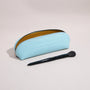 Open rectangular brow pencil pouch holding makeup brushes inside a structured leather case