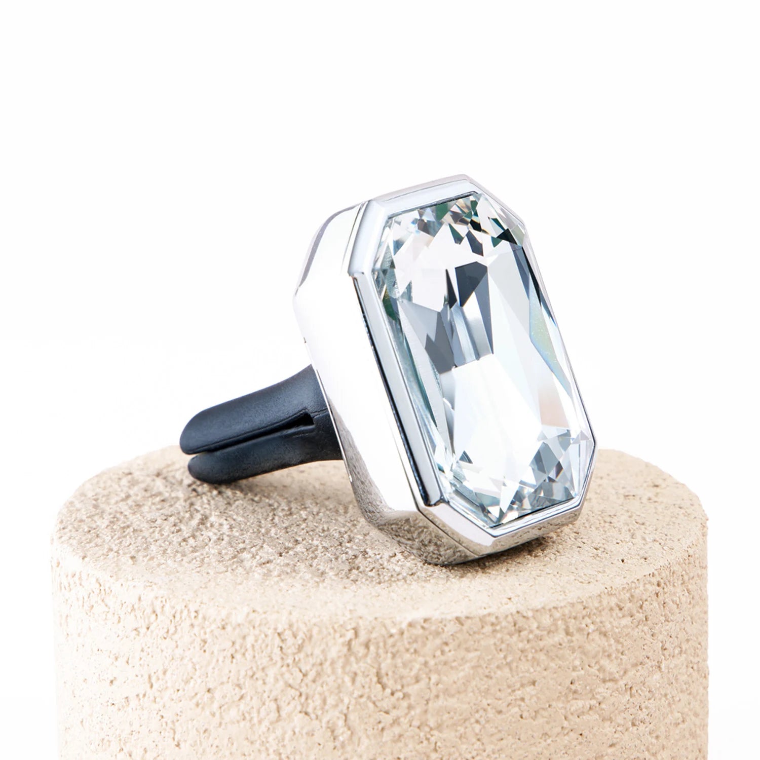 Angled side view of Palladio Prism crystal car diffuser with polished metal frame and black vent clip