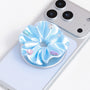 Close-up of a blue 3D-printed jewel rosette phone grip stand with pastel decorative accents on a silver base.