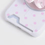 Close-up of the porcelain white oversized polka dot card phone case bottom section with card slot opening and blush-pink dots.
