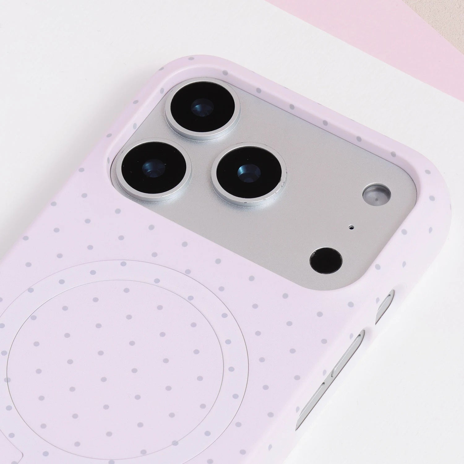 Close-up of the blush pink polka dot phone case camera area with pastel finish and refined dotted pattern.