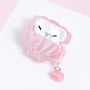 Open pink shell-shaped AirPods case with white AirPods inside, featuring pearl accents, a starfish motif, and a dangling shell pearl charm.