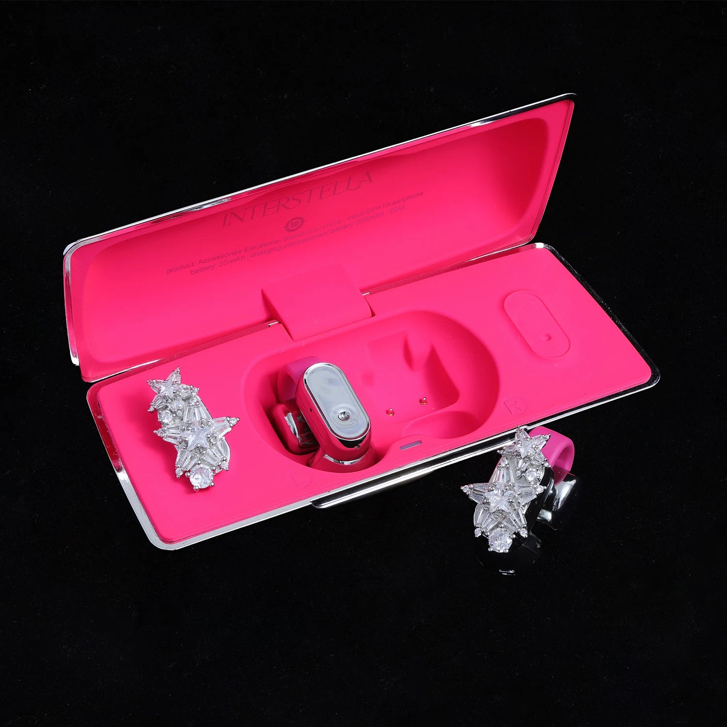 Starburst crystal ear charms displayed with pink Interstella magnetic earphone charging case