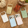 Star phone case collection in white, pink, blue, yellow, red, and green displayed on a wooden table