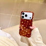 Front view of a deep red shimmering star phone case with gold stars held in hand