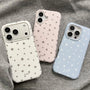 White, blush pink, and baby blue matte star phone cases styled together on grey fabric