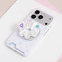 White jewel rosette phone grip stand attached to a white phone case with soft pink polka dots.