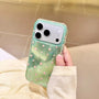 Hand holding a mint green shimmering star phone case with pink stars and clear edges