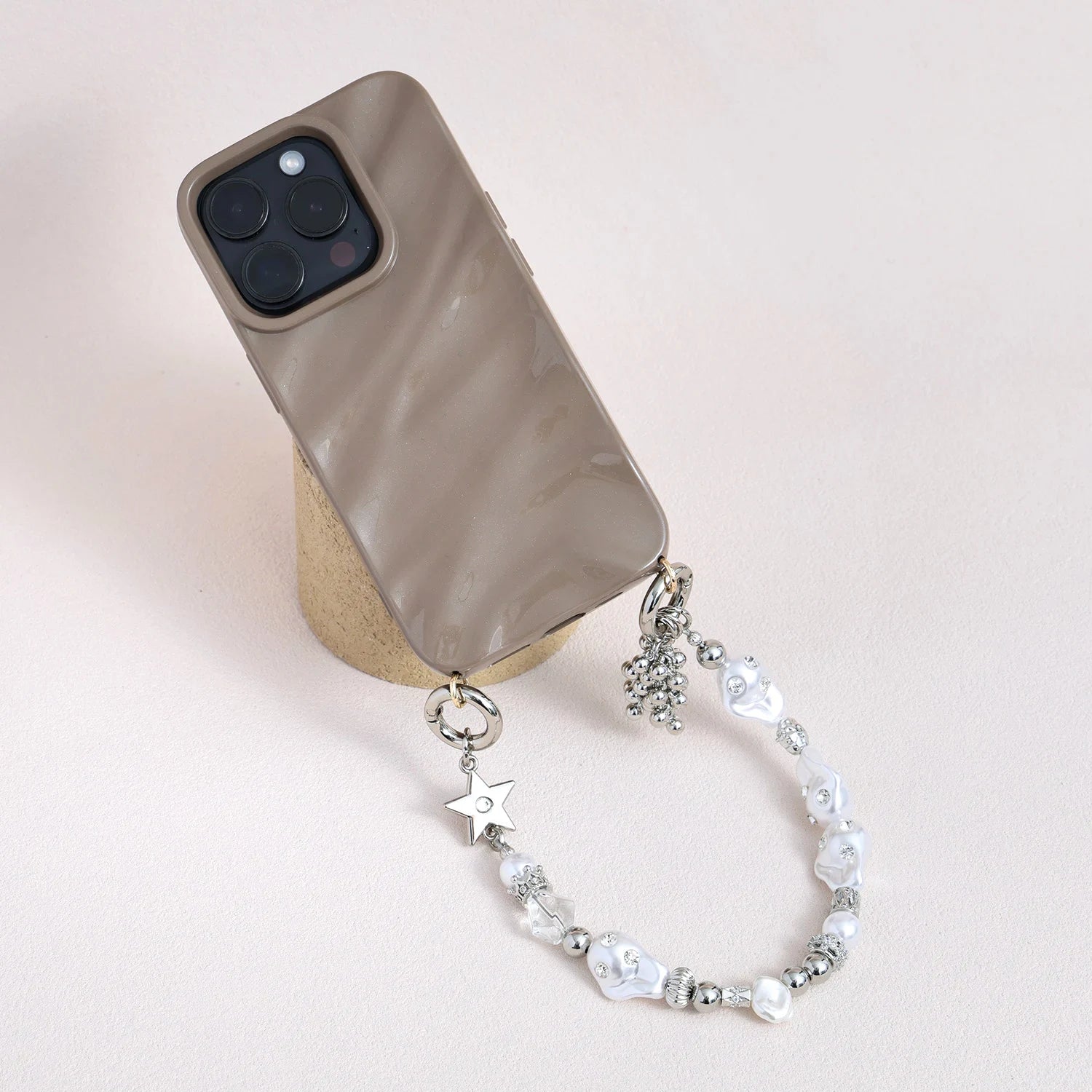 Star-shaped metal and pearl embellished phone strap with mixed metallic bead detailing