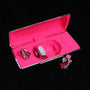 Red gemstone ear charms displayed with pink Interstella magnetic earphone charging case
