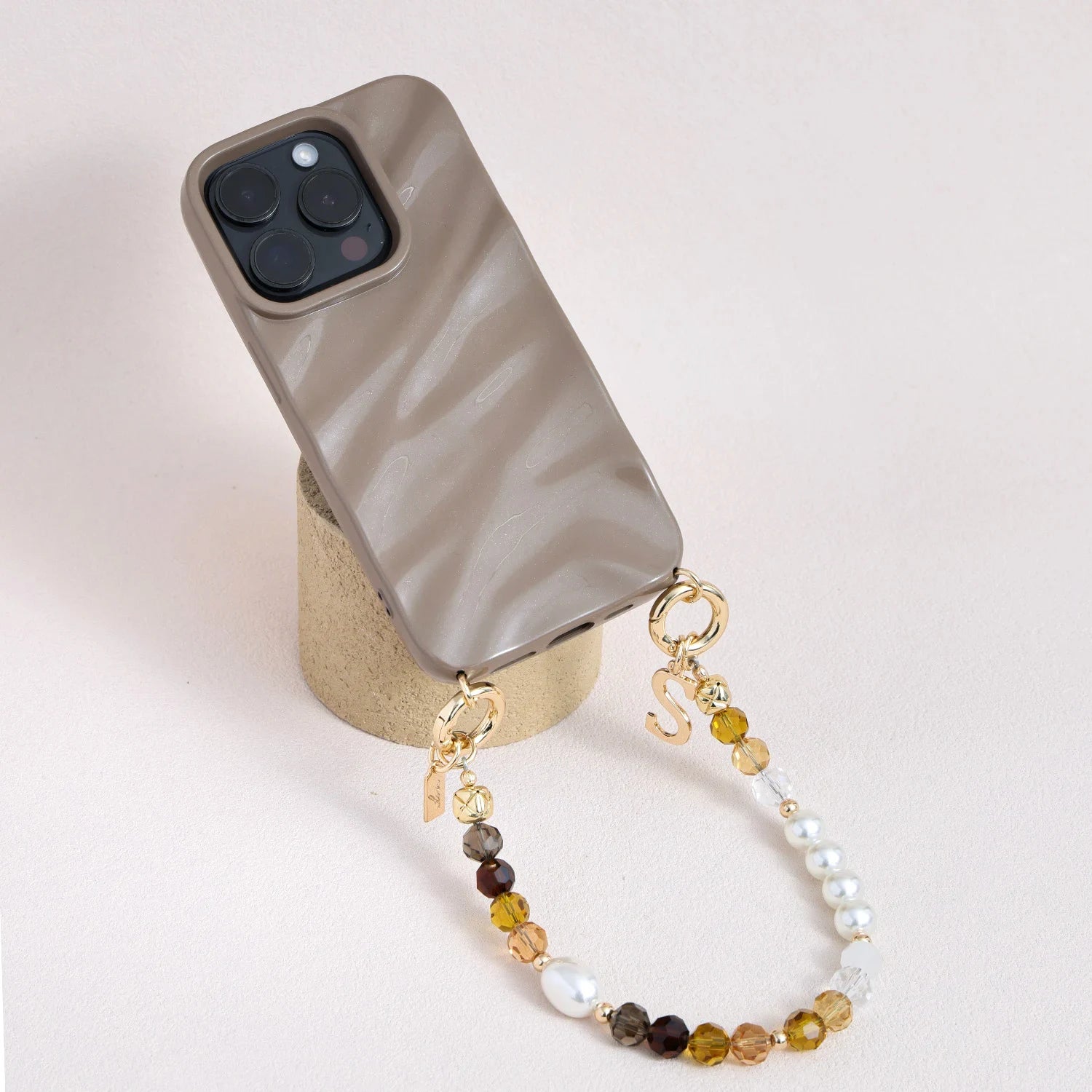 Handcrafted crystal and freshwater pearl phone strap with mixed metal accents and decorative clasp