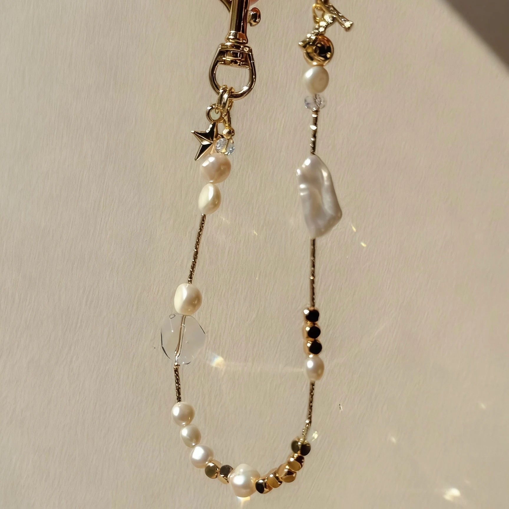 Pearl and white quartz phone strap with gold star charm