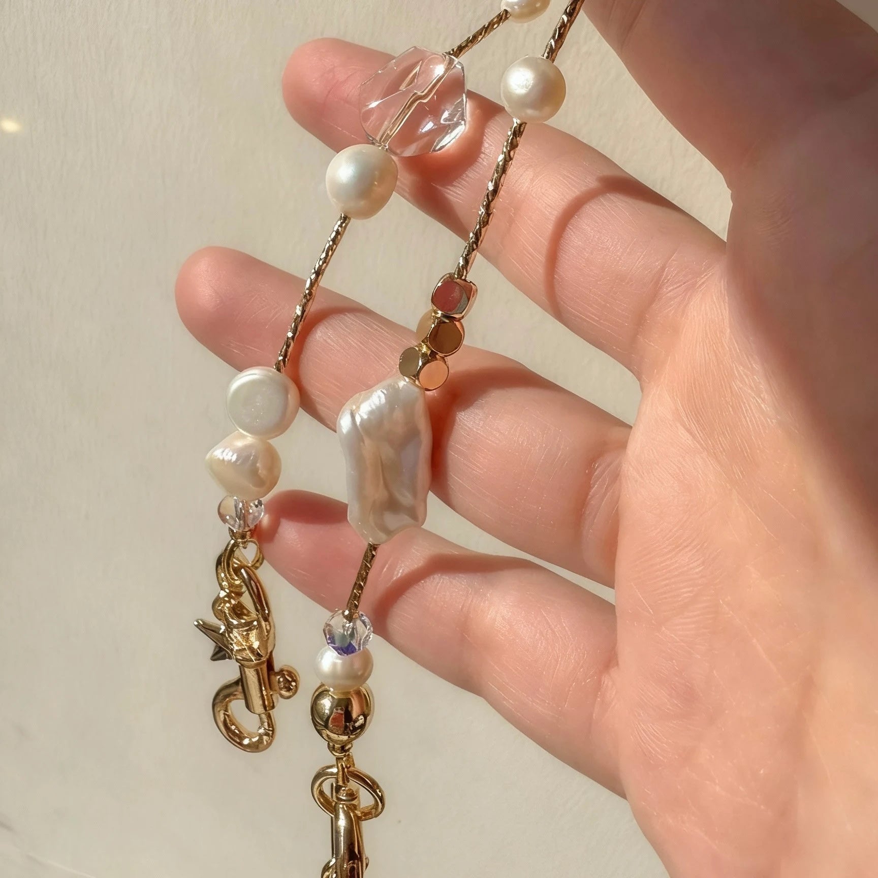 Pearl and white quartz phone strap with gold star charm