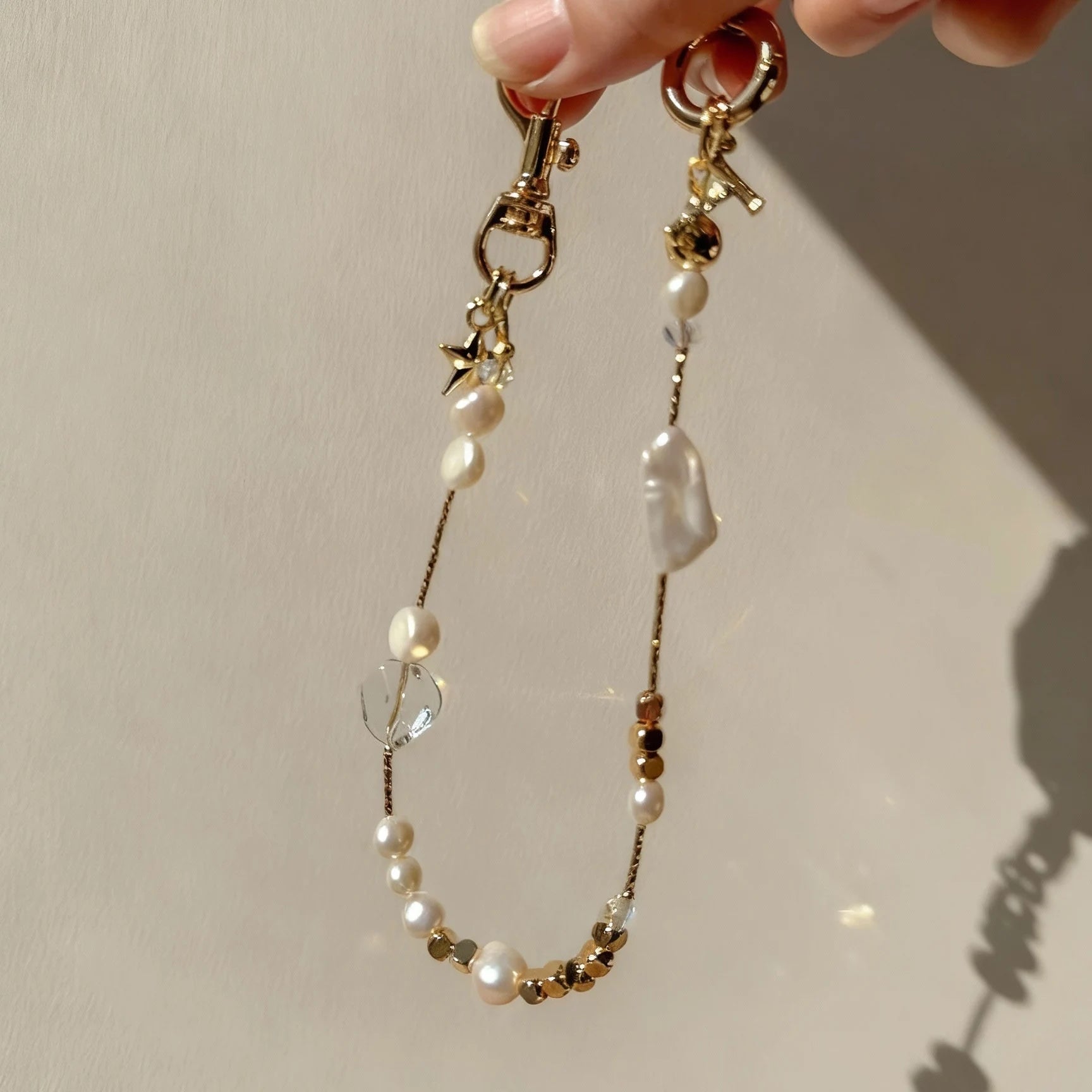 Pearl and white quartz phone strap with gold star charm