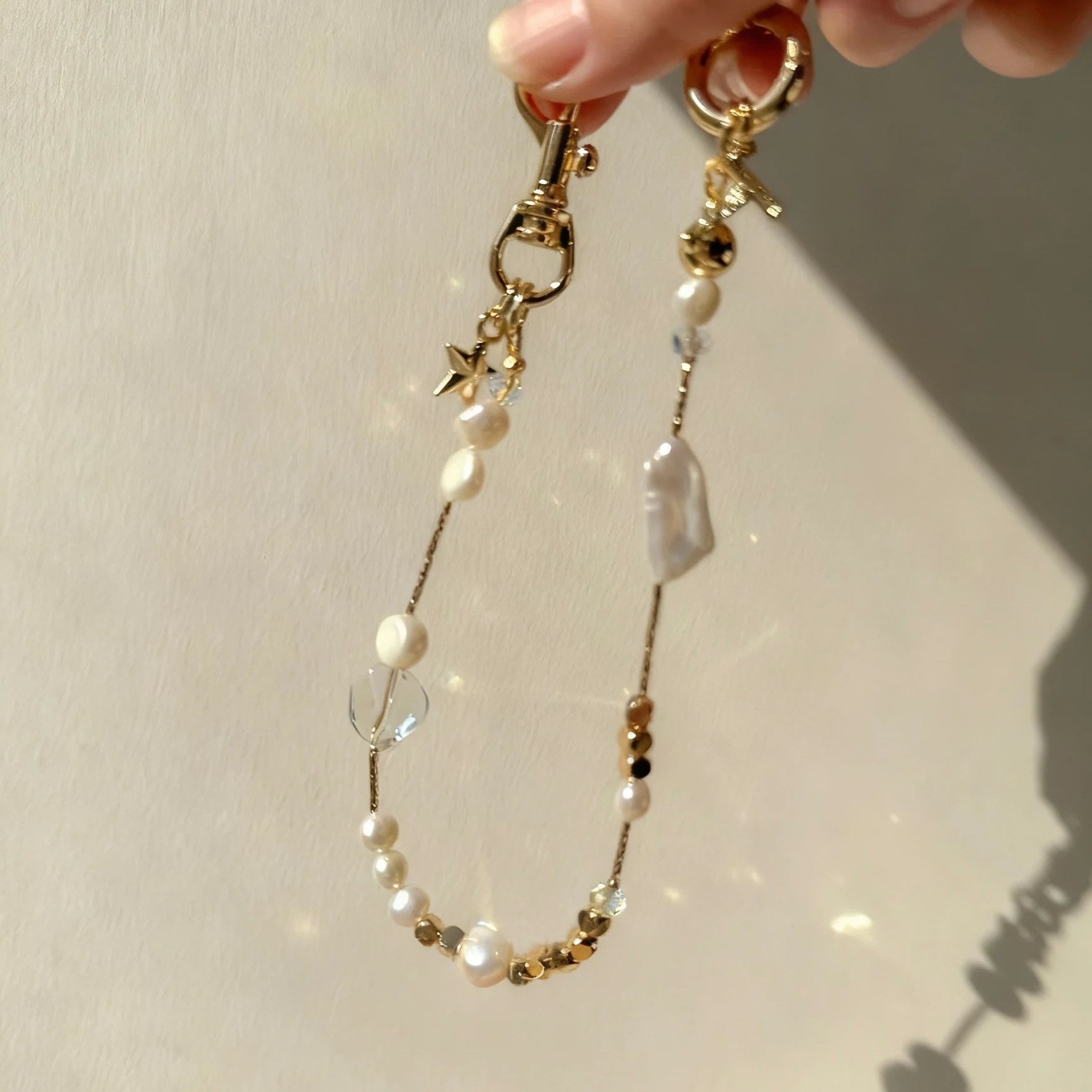 Pearl and white quartz phone strap with gold star charm