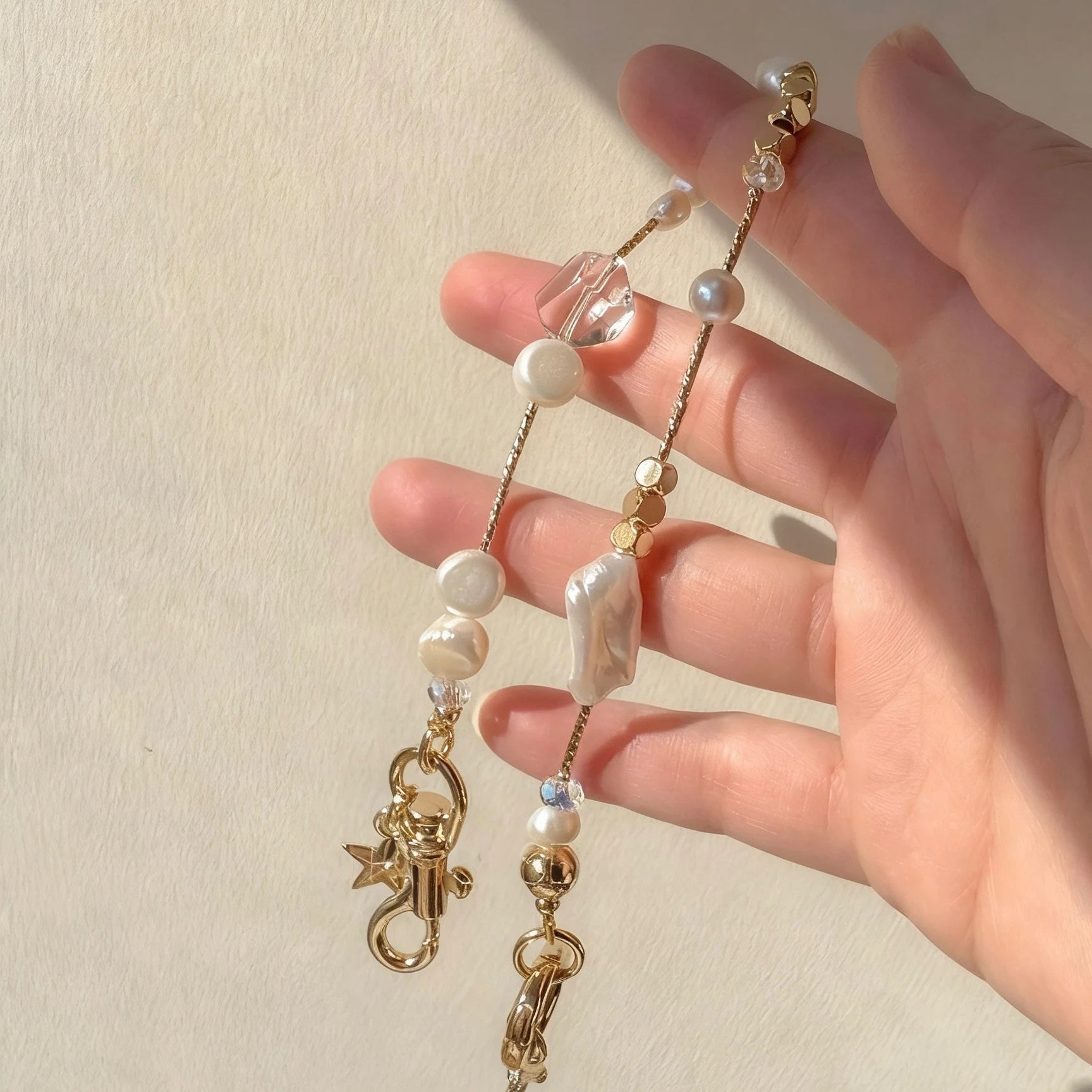 Pearl and white quartz phone strap with gold star charm
