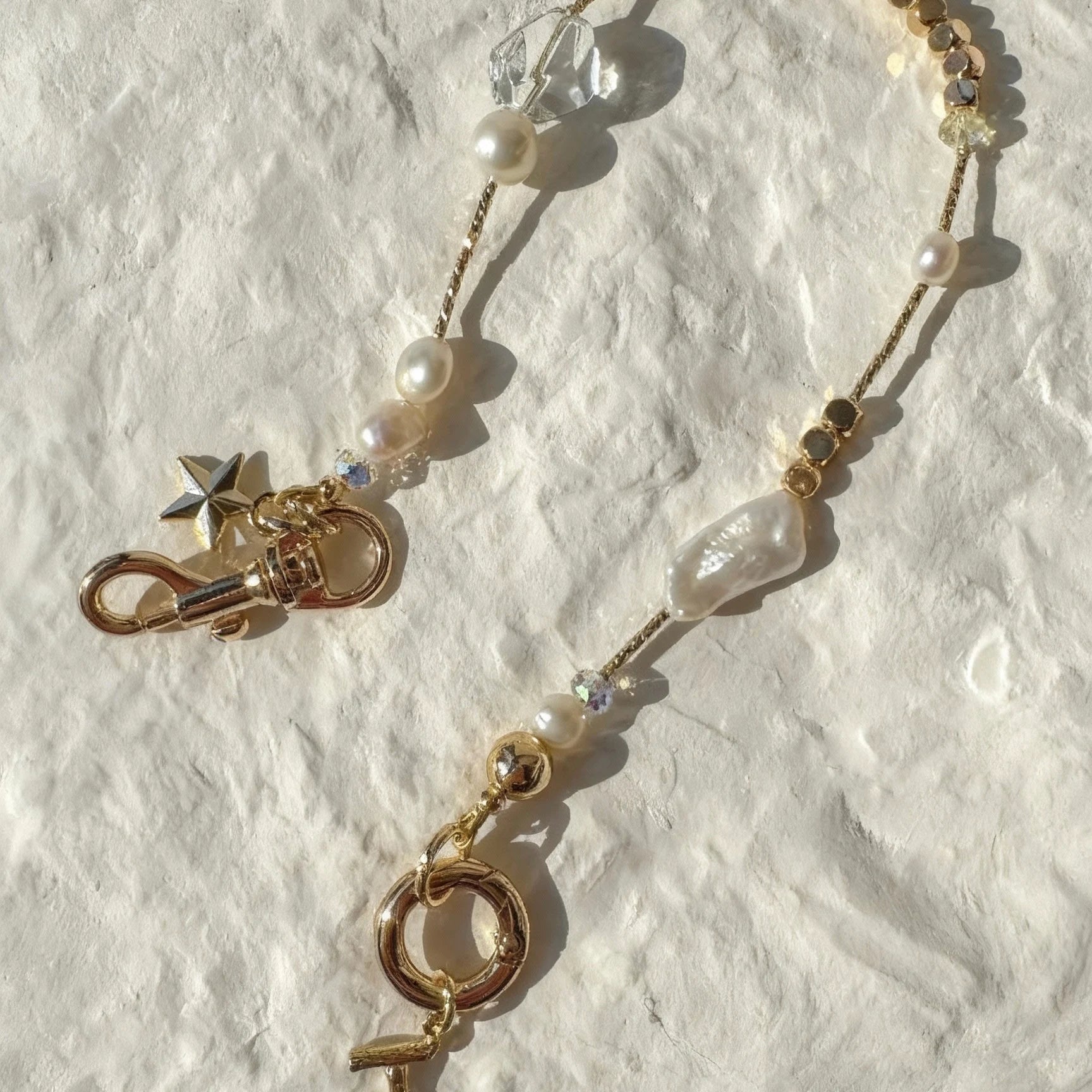 Pearl and white quartz phone strap with gold star charm