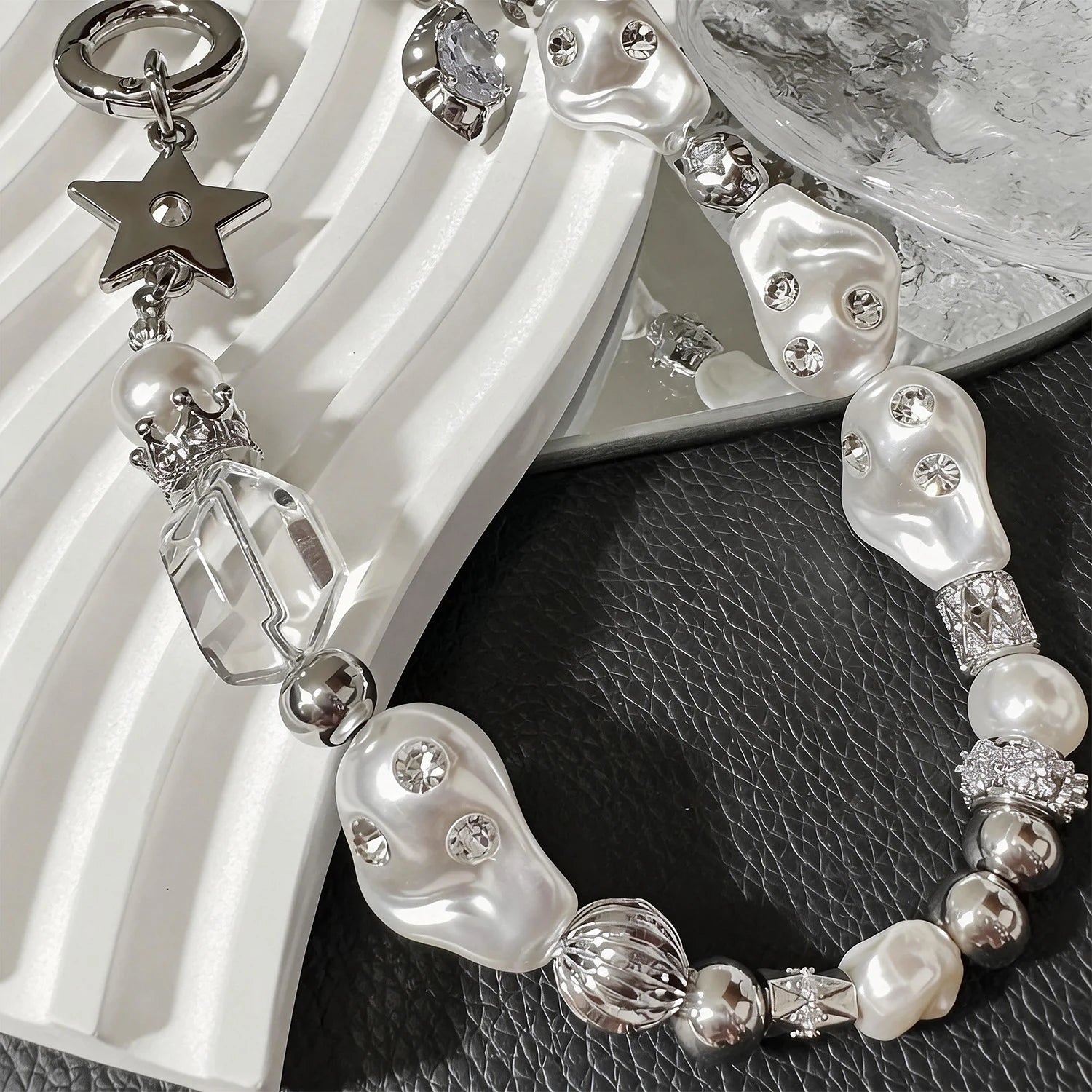 Star-shaped metal and pearl embellished phone strap with mixed metallic bead detailing